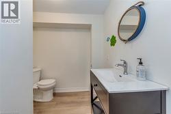 Contemporary vanity with integrated sink, chrome faucet, and dark wood-finish cabinetry - 