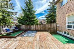 Expansive wooden deck featuring multiple levels and a faux turf accent - 