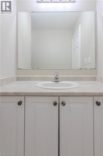 Bathroom vanity featuring a white oval sink, chrome faucet, and integrated light fixture - 3896 Tufgar Crescent, Burlington, ON - Indoor Photo Showing Bathroom