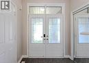 Double entry doors with patterned glass inserts and a transom window, complemented by dark tile flooring and light-toned walls - 3896 Tufgar Crescent, Burlington, ON  - Indoor Photo Showing Other Room 