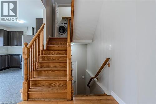 Hardwood staircase featuring wood balusters and a matching handrail - 3896 Tufgar Crescent, Burlington, ON - Indoor Photo Showing Other Room