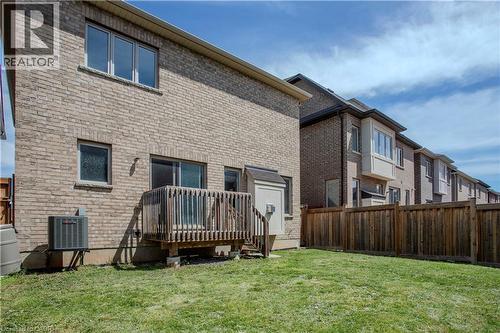 Backyard featuring a wooden deck with railing, a sliding glass door, a brick exterior, and an air conditioning unit - 3896 Tufgar Crescent, Burlington, ON - Outdoor With Deck Patio Veranda With Exterior