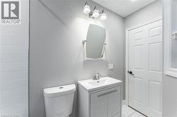 Half bath with vanity and light tile patterned flooring - 