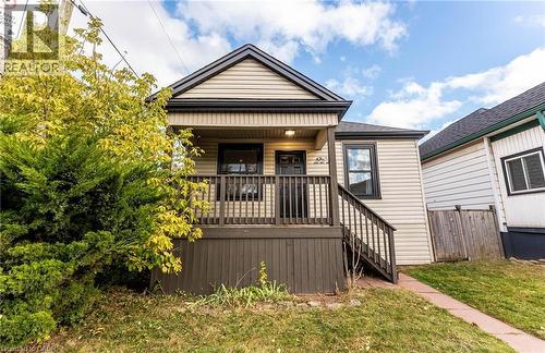 View of front of property featuring stairway and covered porch - 222 Kensington Avenue N, Hamilton, ON - Outdoor With Deck Patio Veranda