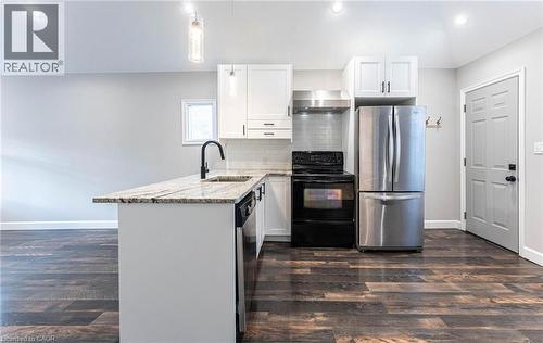 Kitchen featuring stainless steel appliances, backsplash, light stone counters, white cabinets, and recessed lighting - 222 Kensington Avenue N, Hamilton, ON - Indoor Photo Showing Kitchen With Upgraded Kitchen