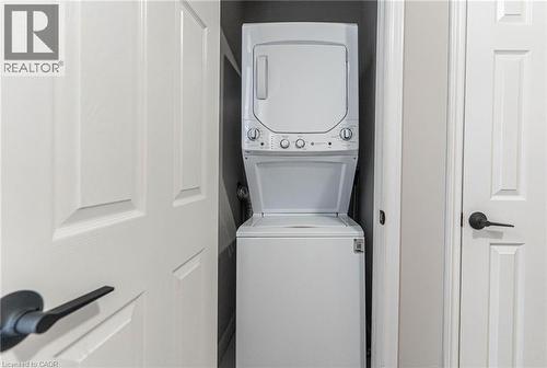 Laundry room featuring stacked washer and clothes dryer - 222 Kensington Avenue N, Hamilton, ON - Indoor Photo Showing Laundry Room