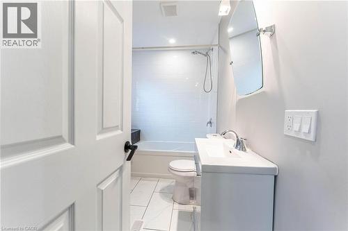Full bathroom with vanity, light marble finish flooring, and bathing tub / shower combination - 222 Kensington Avenue N, Hamilton, ON - Indoor Photo Showing Bathroom