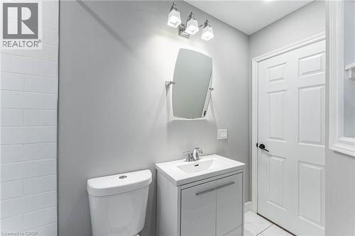Half bath with vanity and light tile patterned flooring - 222 Kensington Avenue N, Hamilton, ON - Indoor Photo Showing Bathroom