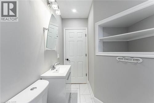 Bathroom featuring vanity and light marble finish floors - 222 Kensington Avenue N, Hamilton, ON - Indoor Photo Showing Laundry Room
