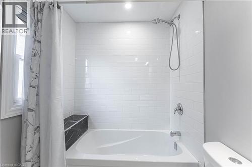 Full bathroom with shower / bath combo with shower curtain and toilet - 222 Kensington Avenue N, Hamilton, ON - Indoor Photo Showing Bathroom