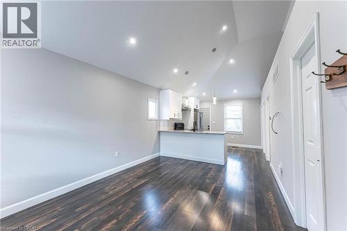 Unfurnished living room featuring lofted ceiling, dark wood-style flooring, and recessed lighting - 222 Kensington Avenue N, Hamilton, ON - Indoor Photo Showing Other Room
