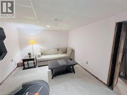 Carpeted room with drop ceiling and recessed lighting - 