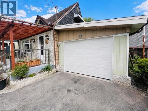 Garage door shown in photo has been virtually added for reference purposes only - 56 Eastvale Place, Hamilton, ON - Outdoor With Exterior