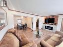 Spacious living area featuring wood-finish flooring, recessed lighting, and crown molding - 56 Eastvale Place, Hamilton, ON  - Indoor Photo Showing Living Room With Fireplace 