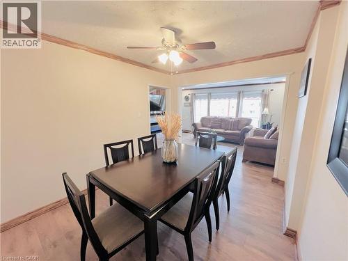 Dining area featuring wood-finish flooring, crown molding, and a ceiling fan with integrated lighting - 56 Eastvale Place, Hamilton, ON - Indoor Photo Showing Dining Room