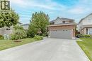 View of front facade with brick siding, concrete driveway, and an attached garage - 32 Vineberg Drive, Hamilton, ON  - Outdoor 