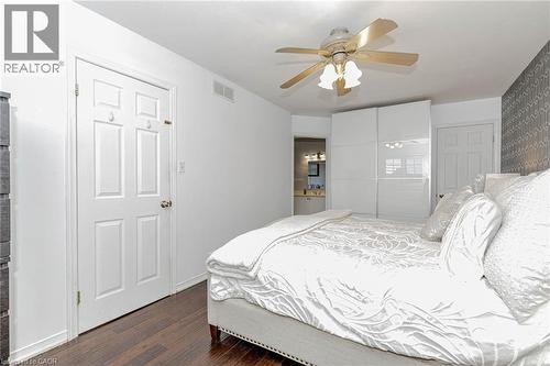 Bedroom with ensuite bath, dark wood-type flooring, a closet, and ceiling fan - 32 Vineberg Drive, Hamilton, ON - Indoor Photo Showing Bedroom