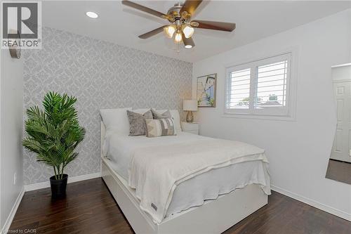Bedroom featuring wallpapered walls, an accent wall, dark wood finished floors, a ceiling fan, and recessed lighting - 32 Vineberg Drive, Hamilton, ON - Indoor Photo Showing Bedroom