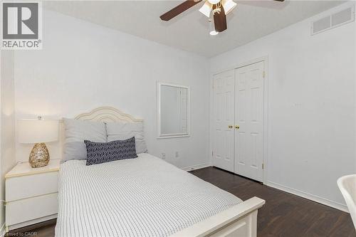 Bedroom featuring dark wood-style flooring, ceiling fan, and a closet - 32 Vineberg Drive, Hamilton, ON - Indoor Photo Showing Bedroom