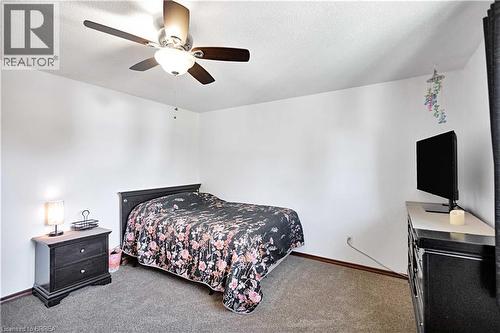 Room with textured ceiling, ceiling fan with integrated lighting, and neutral-toned wall finishes - 16 Sandlewood Avenue, Brantford, ON - Indoor Photo Showing Bedroom