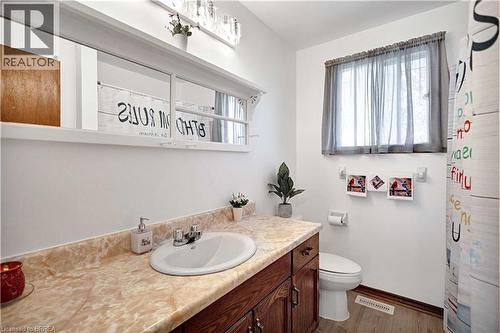 Bathroom with a single vanity featuring a built-in sink and a light-toned countertop - 16 Sandlewood Avenue, Brantford, ON - Indoor Photo Showing Bathroom