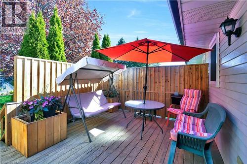 Expansive wood deck featuring a privacy fence, exterior siding, and a wall-mounted light fixture - 16 Sandlewood Avenue, Brantford, ON - Outdoor With Deck Patio Veranda With Exterior