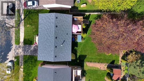 Aerial perspective showcasing the property with a gray shingled roof, a green lawn, and a paved driveway - 16 Sandlewood Avenue, Brantford, ON - Outdoor With Deck Patio Veranda