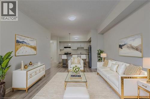 Living area featuring light wood-style flooring and baseboards - 25 Isherwood Avenue Unit# G-105, Cambridge, ON - Indoor Photo Showing Living Room