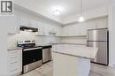 Kitchen with light wood-type flooring, light stone counters, under cabinet range hood, stainless steel appliances, and a sink - 25 Isherwood Avenue Unit# G-105, Cambridge, ON  - Indoor Photo Showing Kitchen With Stainless Steel Kitchen With Upgraded Kitchen 