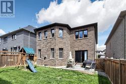 Fully fenced/gated backyard with play set. - 