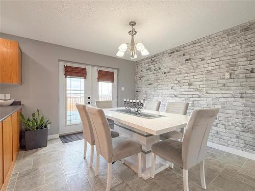 Garden Doors overlooking Backyard - 12 Dominion Way, Brandon, MB - Indoor Photo Showing Dining Room