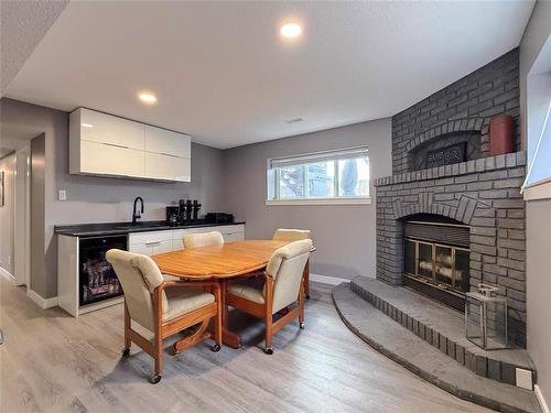 Natural Wood Fireplace - 12 Dominion Way, Brandon, MB - Indoor With Fireplace