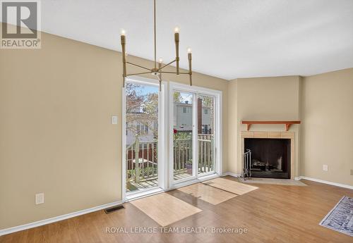 Woodburning FFP serviced by condo corp - 39 Saxton Private, Ottawa, ON - Indoor Photo Showing Living Room With Fireplace