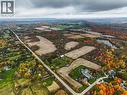 Expansive rural landscape featuring a winding road, cultivated fields, and a tranquil pond - 3415 Cedar Springs Road, Burlington, ON 