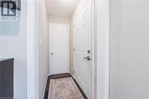Entryway featuring rich wood-finish flooring, white paneled doors, and light neutral wall tones - 242 East 43Rd Street, Hamilton, ON 