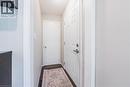 Entryway featuring rich wood-finish flooring, white paneled doors, and light neutral wall tones - 242 East 43Rd Street, Hamilton, ON 