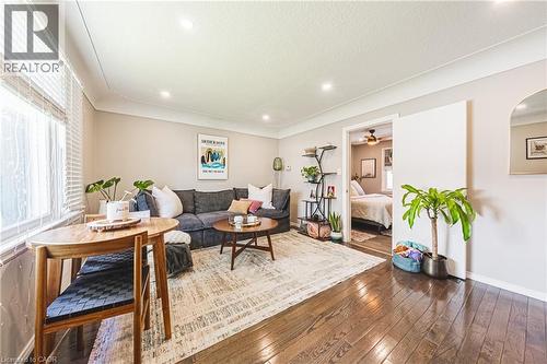 Living area featuring rich wood-finish flooring and recessed lighting - 242 East 43Rd Street, Hamilton, ON 