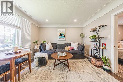Living area featuring light-toned walls, recessed lighting, and crown molding - 242 East 43Rd Street, Hamilton, ON 
