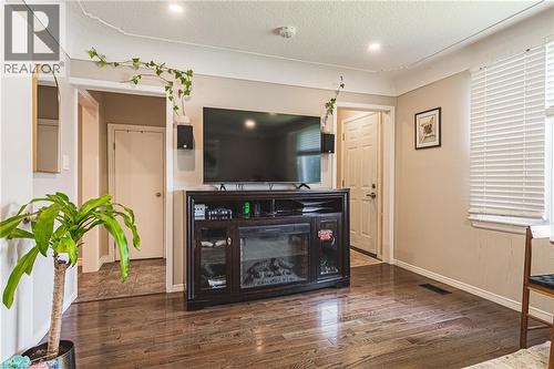 Living area featuring wood-finish flooring, recessed lighting,  with an electric fireplace insert - 242 East 43Rd Street, Hamilton, ON 