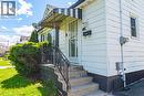Front entrance featuring a striped awning, concrete steps, and ornamental iron railings - 242 East 43Rd Street, Hamilton, ON  - Outdoor With Exterior 
