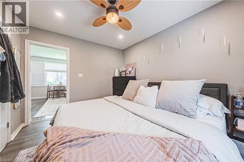 Recessed lighting illuminating a spacious room with a wood-finish ceiling fan, wood-finish flooring, and a neutral color palette - 242 East 43Rd Street, Hamilton, ON - Indoor Photo Showing Bedroom