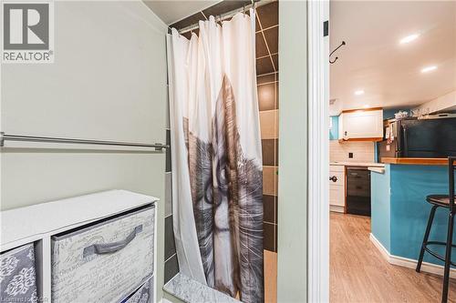 Shower stall featuring brown and beige tiled walls - 242 East 43Rd Street, Hamilton, ON - Indoor