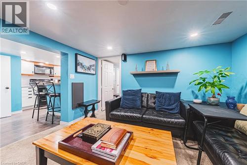 Living area with recessed lighting, integrated wall shelving, and an open concept layout connecting to a kitchen - 242 East 43Rd Street, Hamilton, ON - Indoor Photo Showing Living Room