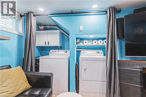 Dedicated laundry area featuring a washer and dryer, recessed lighting, built-in shelving, and white cabinetry - 242 East 43Rd Street, Hamilton, ON - Indoor Photo Showing Laundry Room