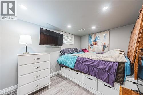 Bedroom featuring wood-finish flooring, recessed lighting, and a window with blinds - 242 East 43Rd Street, Hamilton, ON - Indoor Photo Showing Bedroom