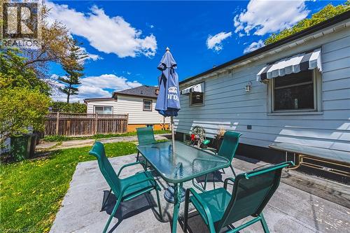 Backyard patio featuring a concrete slab and partial wood deck - 242 East 43Rd Street, Hamilton, ON - Outdoor With Deck Patio Veranda