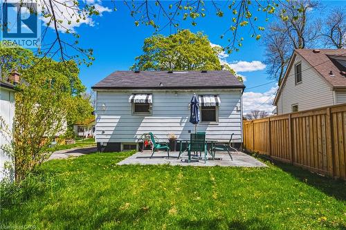 Expansive backyard featuring a manicured lawn, a rectangular concrete patio, and a privacy fence - 242 East 43Rd Street, Hamilton, ON - Outdoor