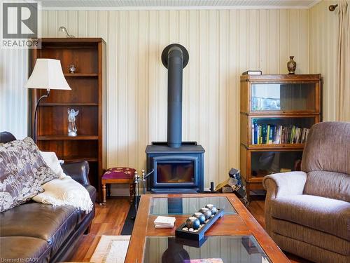 Living area featuring a freestanding wood-burning stove. - 1395 Lakeshore Road, Haldimand County, ON - Indoor Photo Showing Living Room