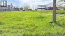 Expansive open land featuring green grass and visible utility poles - 6 Brydges Street, Paris, ON 