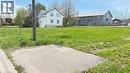 Expansive green lot featuring a paved section and visible utility pole - 6 Brydges Street, Paris, ON 